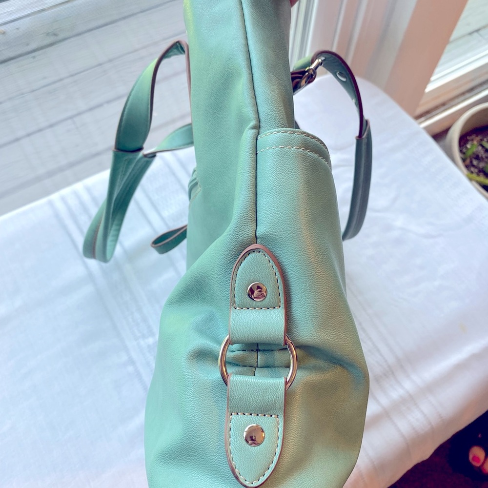 Teal bag with multiple pockets.